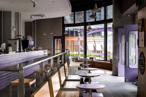 Inviting restaurant interior with multiple tables and chairs, comfortable seating options, and a warm atmosphere