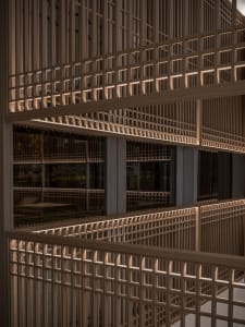 A multi-level building with wooden walls and floors, featuring windows and a blend of traditional and modern elements