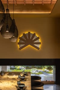 Inviting dining area with a yellow wall, a table, chairs, and decorative vases