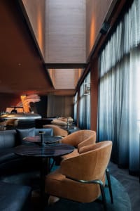 A restaurant interior with multiple tables and chairs, creating a welcoming atmosphere for guests to enjoy their meals