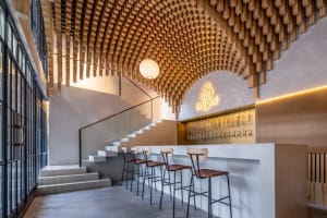 A cozy bar area with a counter and multiple stools, creating a comfortable seating arrangement for customers