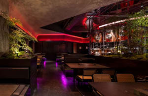 A restaurant dining area with multiple tables and chairs, creating an inviting and comfortable atmosphere for guests