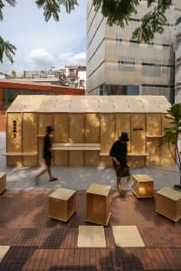 A public area with a wooden structure and chairs, suggesting a gathering place within a building