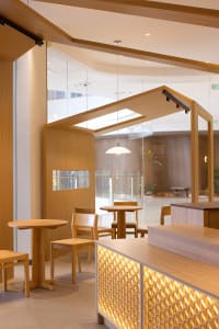 Warm and inviting restaurant interior with wooden tables and chairs, creating a cozy atmosphere