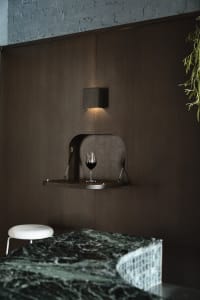 Cozy dining room with dark wood paneling, a dining table, and two chairs, designed for relaxation and socializing
