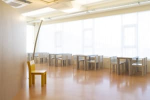 A well-lit classroom with multiple chairs in various positions, conveying a sense of organization and functionality