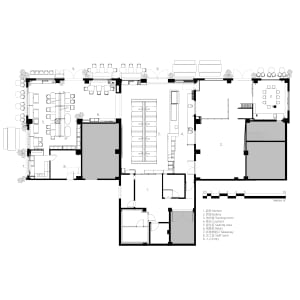 2D floor plan of a modern restaurant with various rooms and spaces labeled, featuring clear lines, minimalistic design, and predominantly white materials