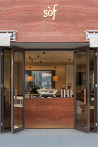 Warm and inviting cafe interior with wooden floors and walls, featuring cups and surfaces with a focus on comfort and relaxation