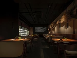 A dimly lit restaurant with numerous wooden tables and chairs, creating a warm and inviting atmosphere