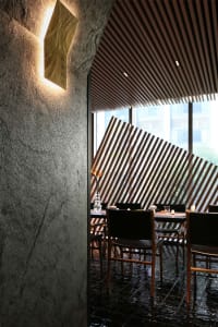Formal dining area with a long table and multiple chairs, set up for a meal in a restaurant