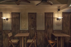 Cozy restaurant interior with wooden tables, chairs, and walls, creating a warm and inviting atmosphere