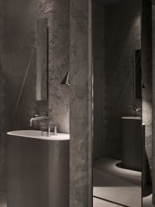 Modern bathroom with a metal bathtub and a minimalist sink, featuring a clean and sophisticated atmosphere with a focus on functionality and contemporary design