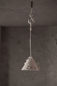 A restaurant interior with a sand sculpture hanging from the ceiling, showcasing intricate design elements and architectural details