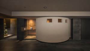 A bright and airy interior design concept featuring a circular room with a curved wall, large windows, and concrete walls