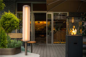 Inviting restaurant space with a dining area, chairs, and potted plants