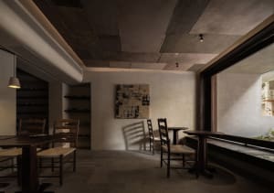 Dimly lit restaurant interior with wooden tables, chairs, and paneling, creating a warm and inviting atmosphere
