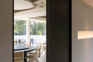 A dining area with a round table and multiple chairs, set in a restaurant or well-equipped home, conveying a comfortable atmosphere