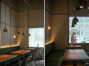 Warm and inviting restaurant interior with wooden tables and chairs, multiple dining tables, and benches, well-designed lighting creating a comfortable ambiance