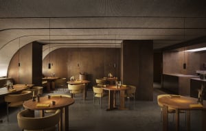 Warm and inviting restaurant with wooden floors and walls, featuring dining tables and comfortable seating, with various items on the tables