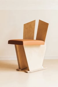 Empty minimalist room with a wooden chair and white walls, giving the space a clean and simple appearance