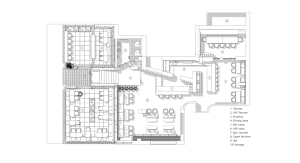 A modern interior space with various seating options, including chairs near the center and along the walls