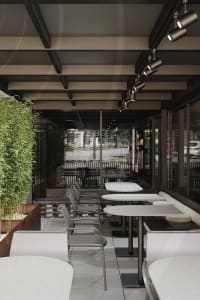 A modern dining area with multiple tables and chairs, creating a comfortable atmosphere for guests to enjoy their meals