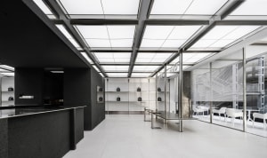 Empty modern room with white walls, black cabinets, and well-lit space