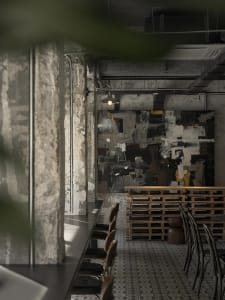 Cozy restaurant interior with wooden tables and chairs, soft ambient lighting, and a warm atmosphere