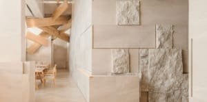 Contemporary interior space with a large marble wall, two chairs, and a sophisticated atmosphere