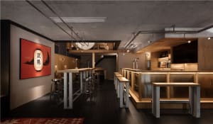 A cozy bar area with a wooden countertop, stools, and chairs, creating a welcoming atmosphere for patrons