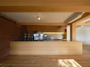 Warm and inviting kitchen with wooden floors and cabinets, featuring a microwave, oven, refrigerator, and various kitchen utensils