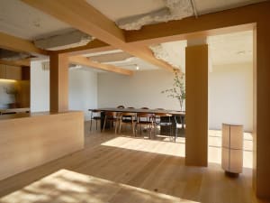 Cozy modern living space with a dining table and chairs, well-lit by natural and artificial light