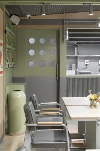 A cozy kitchen dining space with a wooden table surrounded by metal chairs, creating a warm and inviting atmosphere for meals and gatherings