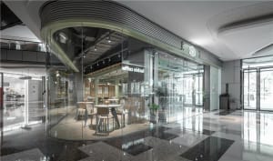 Bright and inviting restaurant interior with multiple tables, chairs, and potted plants