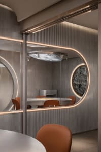 A modern dining area with a round wooden table surrounded by four metal chairs, creating an inviting atmosphere