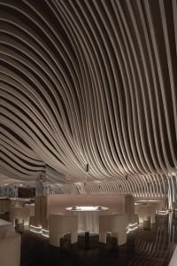 A modern restaurant interior with multiple dining tables and chairs, creating a comfortable and inviting atmosphere for guests