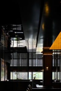 Elegant restaurant interior with multiple dining tables and chairs, clean lines, and minimalist design elements