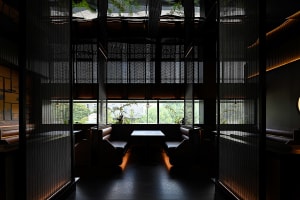 A well-lit dining area with multiple tables and chairs, creating a comfortable seating arrangement for guests