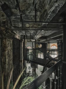 Modern interior space with a staircase, chairs placed around the area, and a well-designed atmosphere