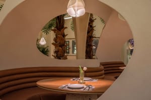 Warm and inviting dining space with wooden furniture, potted plants, and soft lighting