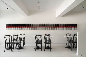 Formal dining area with multiple tables and chairs, utensils, and a well-organized atmosphere