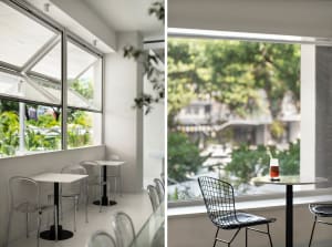 A restaurant with multiple dining tables and chairs, both inside and out, creating a welcoming atmosphere for guests