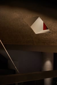 A modern concrete building with a hole in its side, showcasing its functional design and daytime lighting