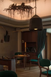 Cozy dining room with a wooden dining table and chairs, a couch, and various decorative items