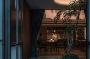 Warm and inviting dining area with a wooden table surrounded by chairs and natural light