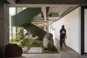 Cozy living and dining space with chairs, a natural rock focal point, and a warm atmosphere