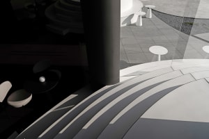 A modern building with a large pillar and several tables in a minimalist space with clean lines and simple design elements