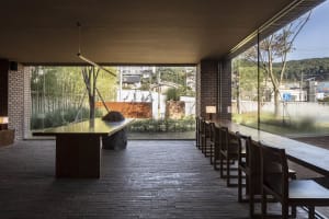 A modern restaurant interior with tables, chairs, and a warm inviting atmosphere created by thoughtful lighting