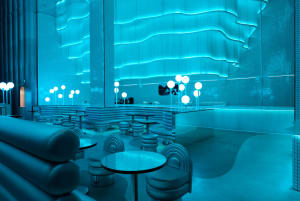 Bright and inviting restaurant interior with modern design, natural light, and multiple tables and chairs