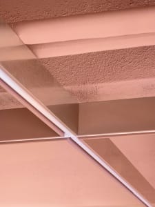 A cozy room with a pink wall and ceiling, creating a warm atmosphere